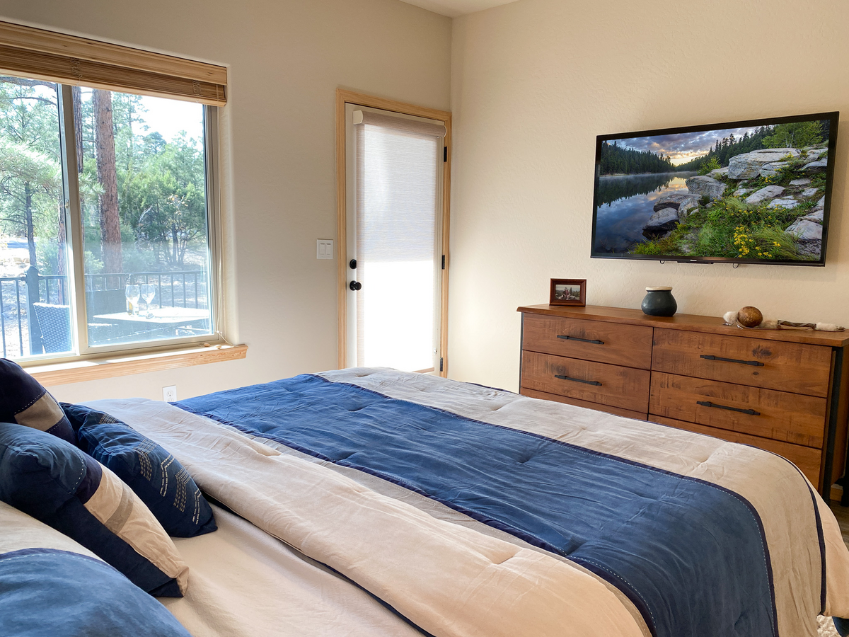 Private smart TV and private door to the deck in the main bedroom.