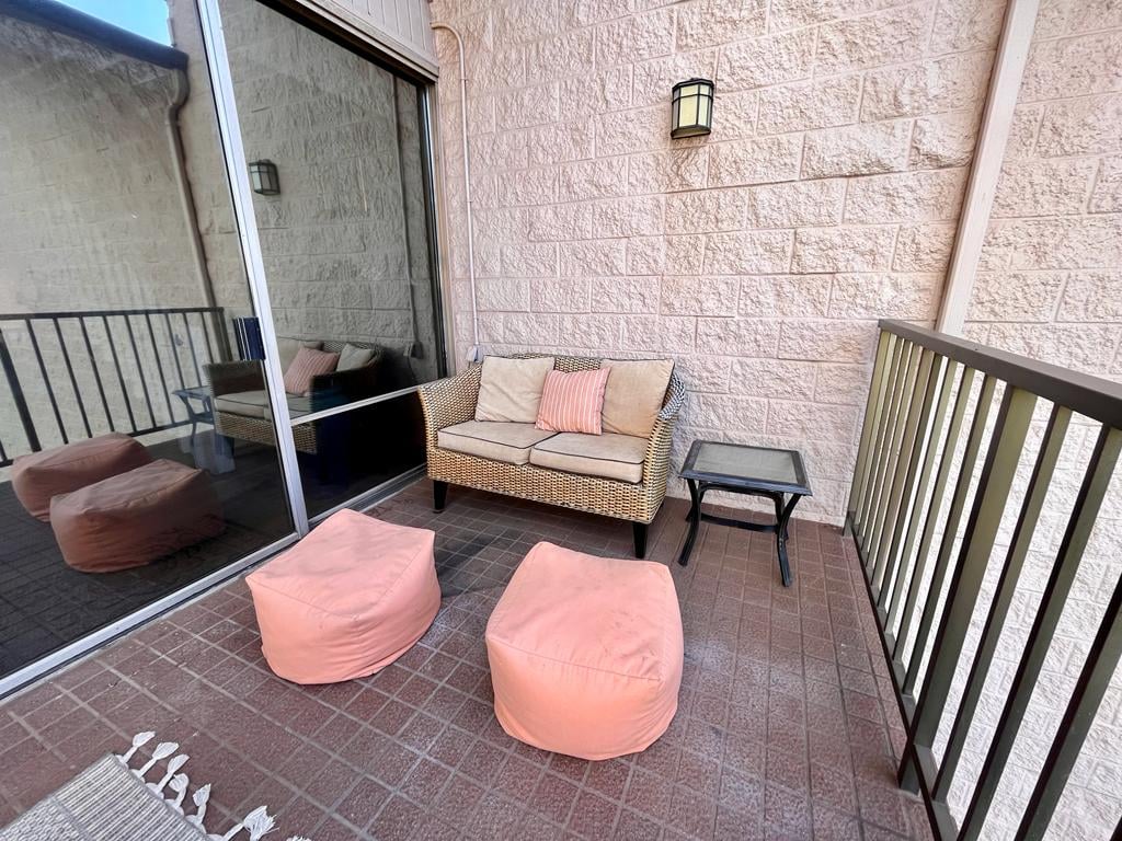 Your spacious balcony with table and chairs!