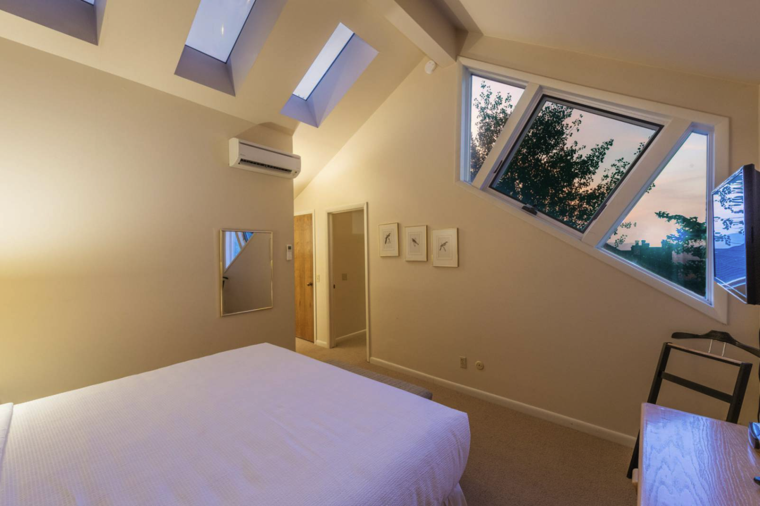 Top floor Master Bedroom with King bed and ensuite bathroom. Funky windows and great views!
