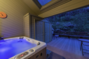 Private deck with privacy and hillside views, private hot tub to relax at the end of a long day playing!