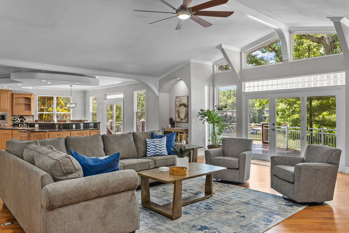 Living room is highlighted by large seating capacity sofa set, a nice nature view and an open concept design.