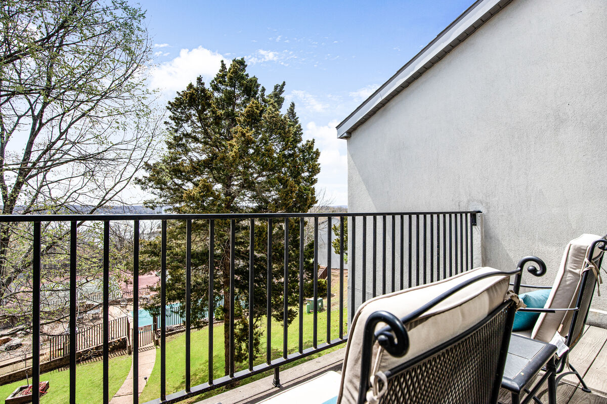 The view from your balcony includes pool, tennis courts, and a distant lake view.