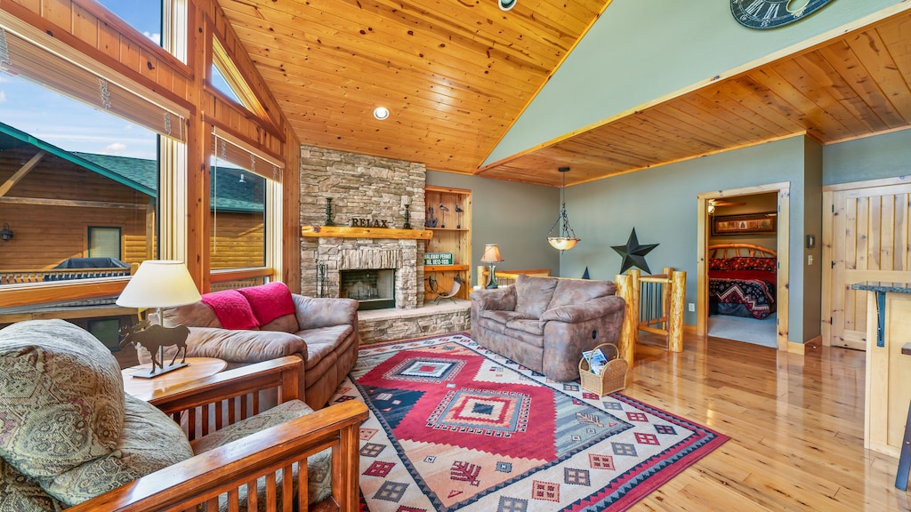 Views are complimented by beautiful woodwork and stone fireplace.