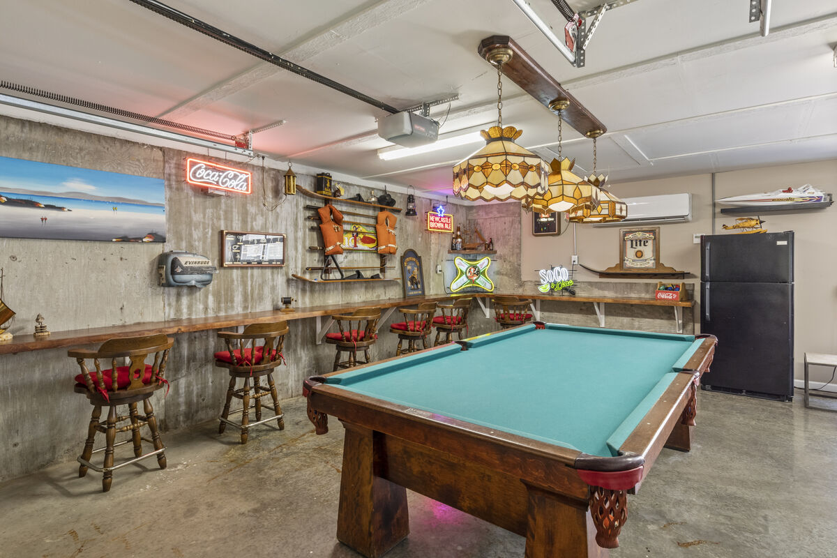 Amazing game room with pool table, darts, video games, and great seating.