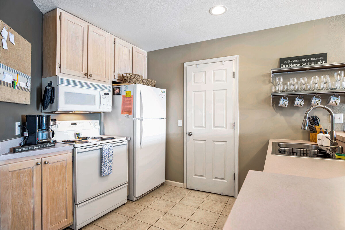 Well equipped appliances with pantry adjacent to kitchen