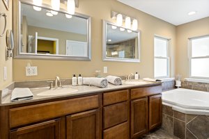 Spacious master bathroom with walk-in closet and double vanity.