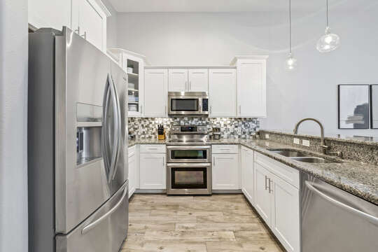 Spacious kitchen with stainless steel appliances.