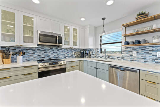 Beautiful renovated kitchen with coastal backsplash!