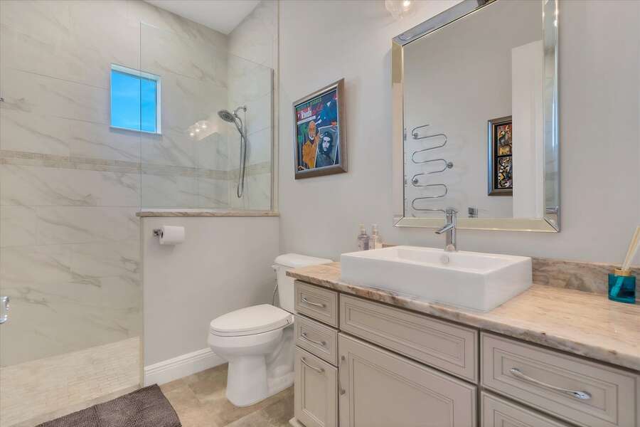 Guest bathroom featuring large walk-in shower