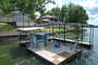 Dock with wet steps, boat slip, and PWC Lift