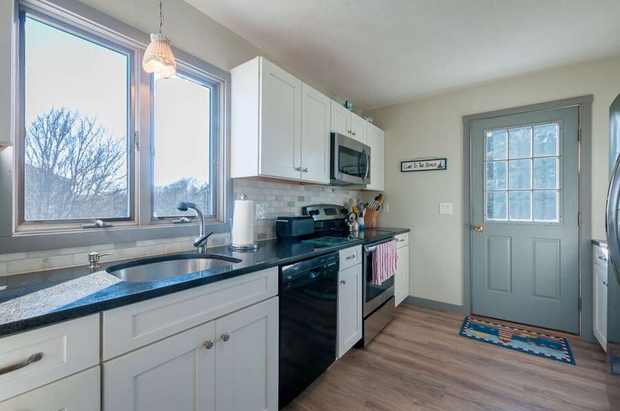Fully equipped kitchen with dishwasher and toaster.