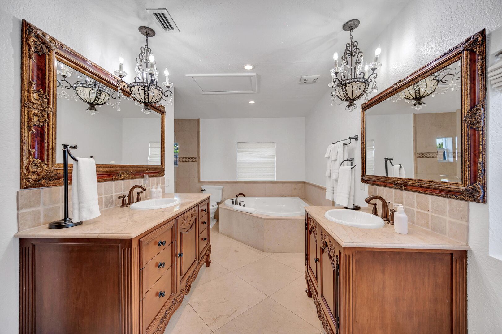Both bedrooms four and five share a bathroom featuring two vanities, a bathtub and walk-in shower.