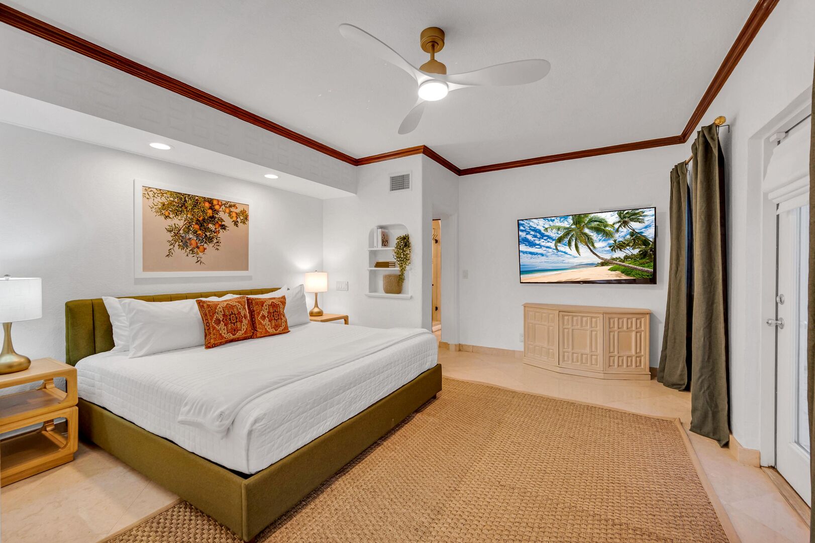 The ample primary bedroom features a king size bed and smart TV.