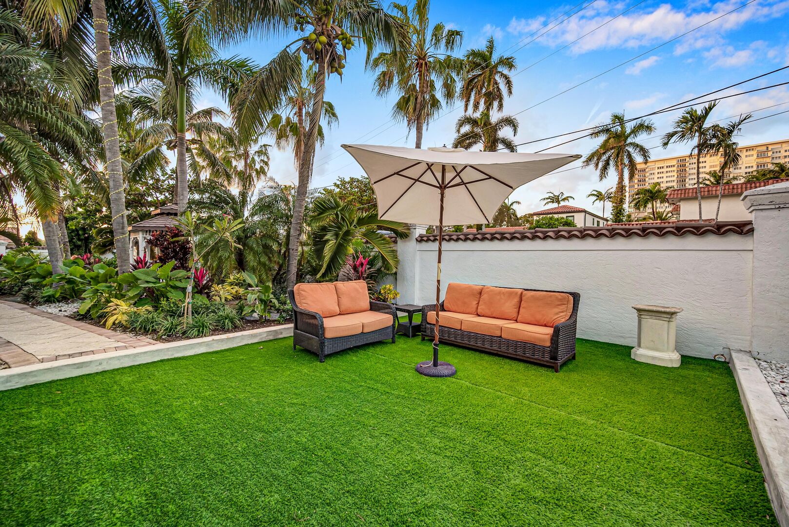 The lush outdoor patio accessible from bedrooms two and three.