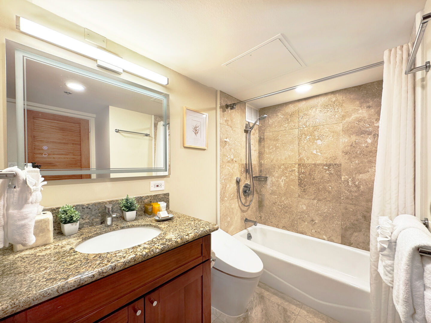 The master bedroom has a bathroom with tub and shower combo, and a vanity with cabinet.