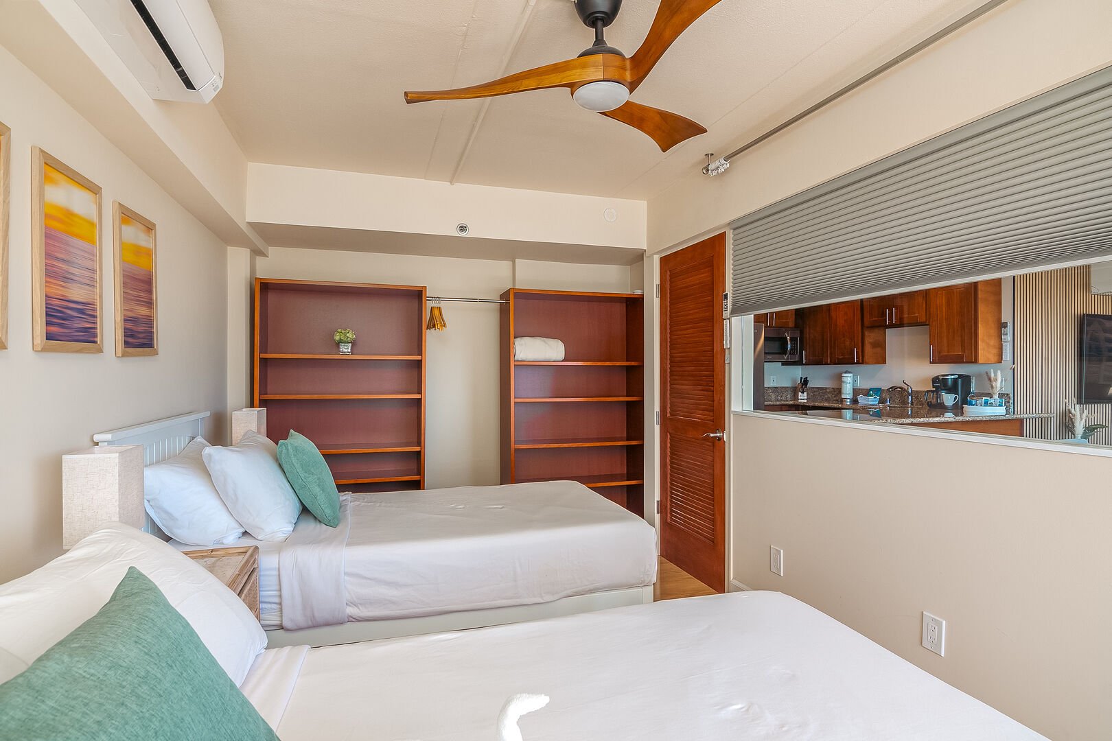 The second bedroom with cabinets and a ceiling fan, motorized window blinds offers the option of having privacy or connecting the room and view to the rest of the living space.