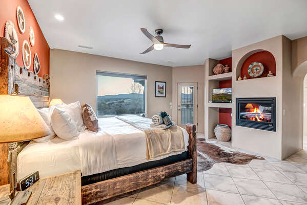 Master Bedroom with King-Size Bed, Smart TV, Gas Fireplace, Direct Backyard, and En Suite Bathroom