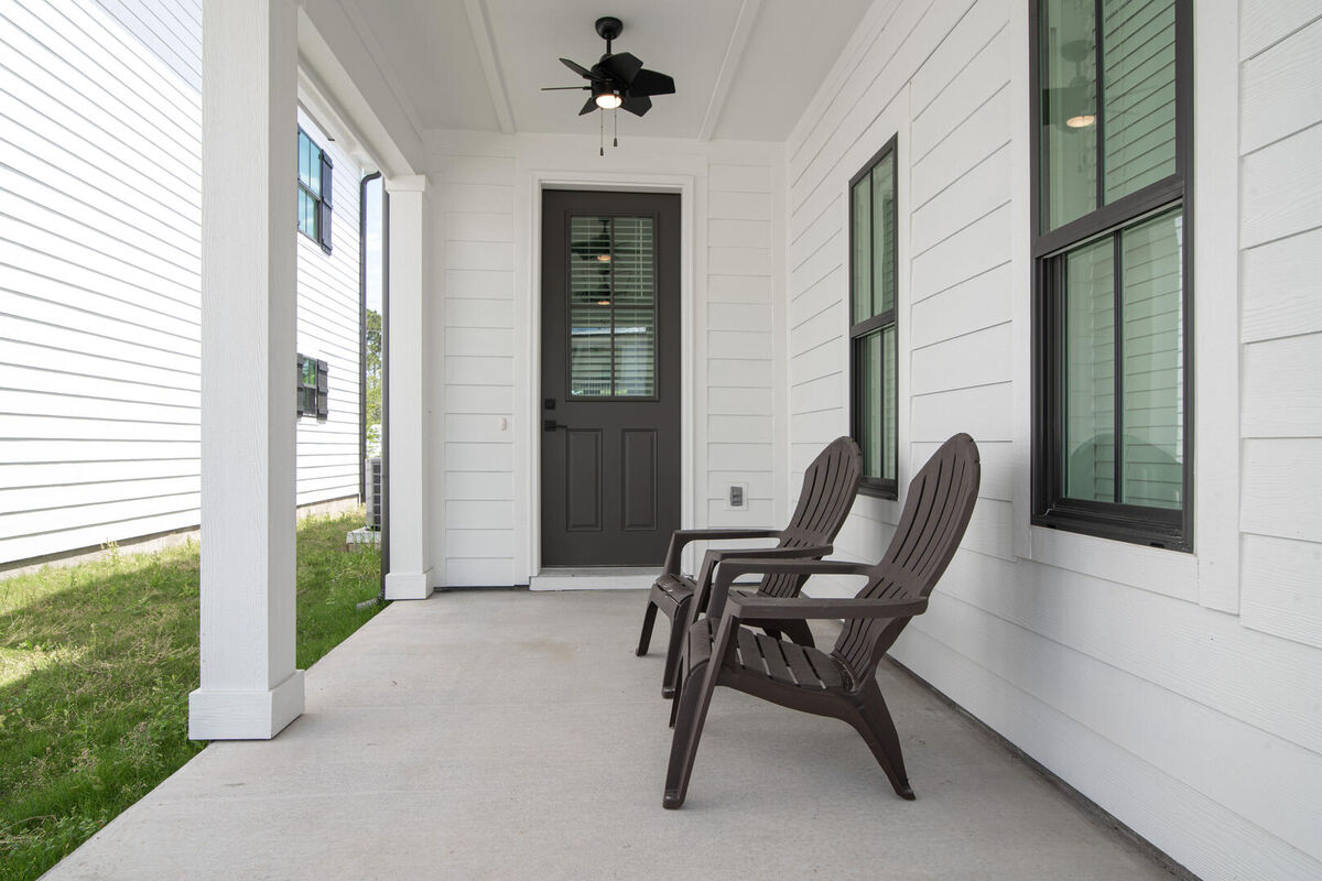 Front door to home with patio seating
