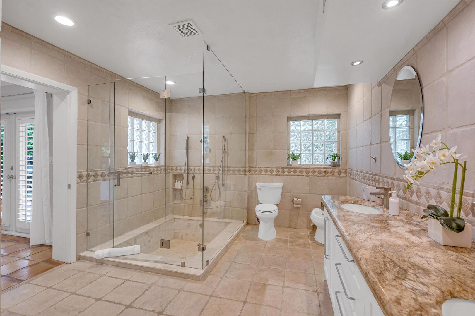 The master bathroom features a double vanity and a step in shower that can double as a large tub.
