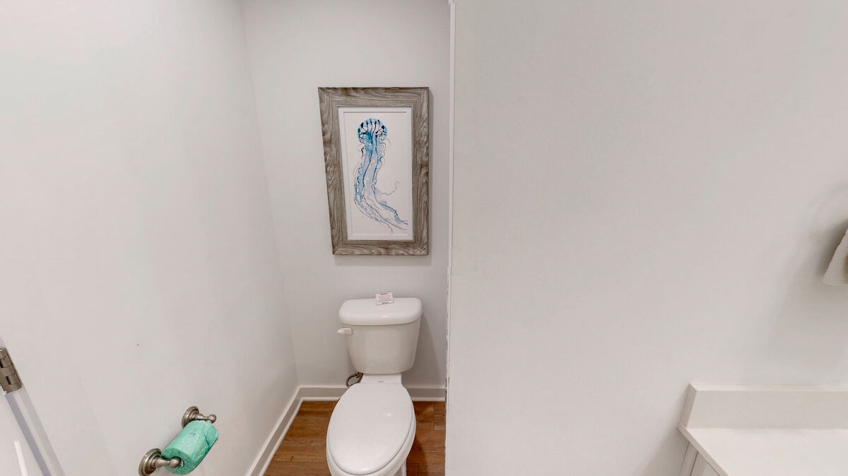 The bathroom on the first floor offers functionality and elegance for your guests' comfort and convenience.