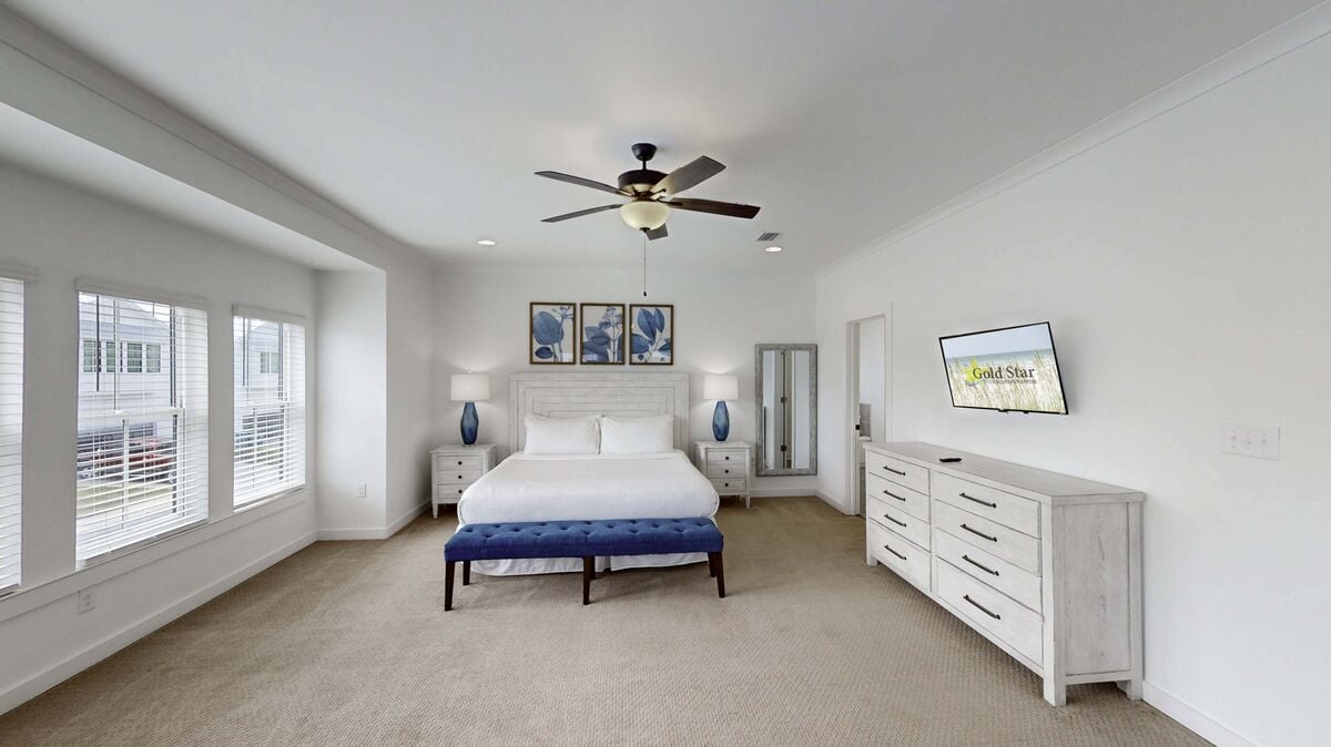 The cozy king size bed invites you for a restful night's sleep enveloped in its plush furnishings.