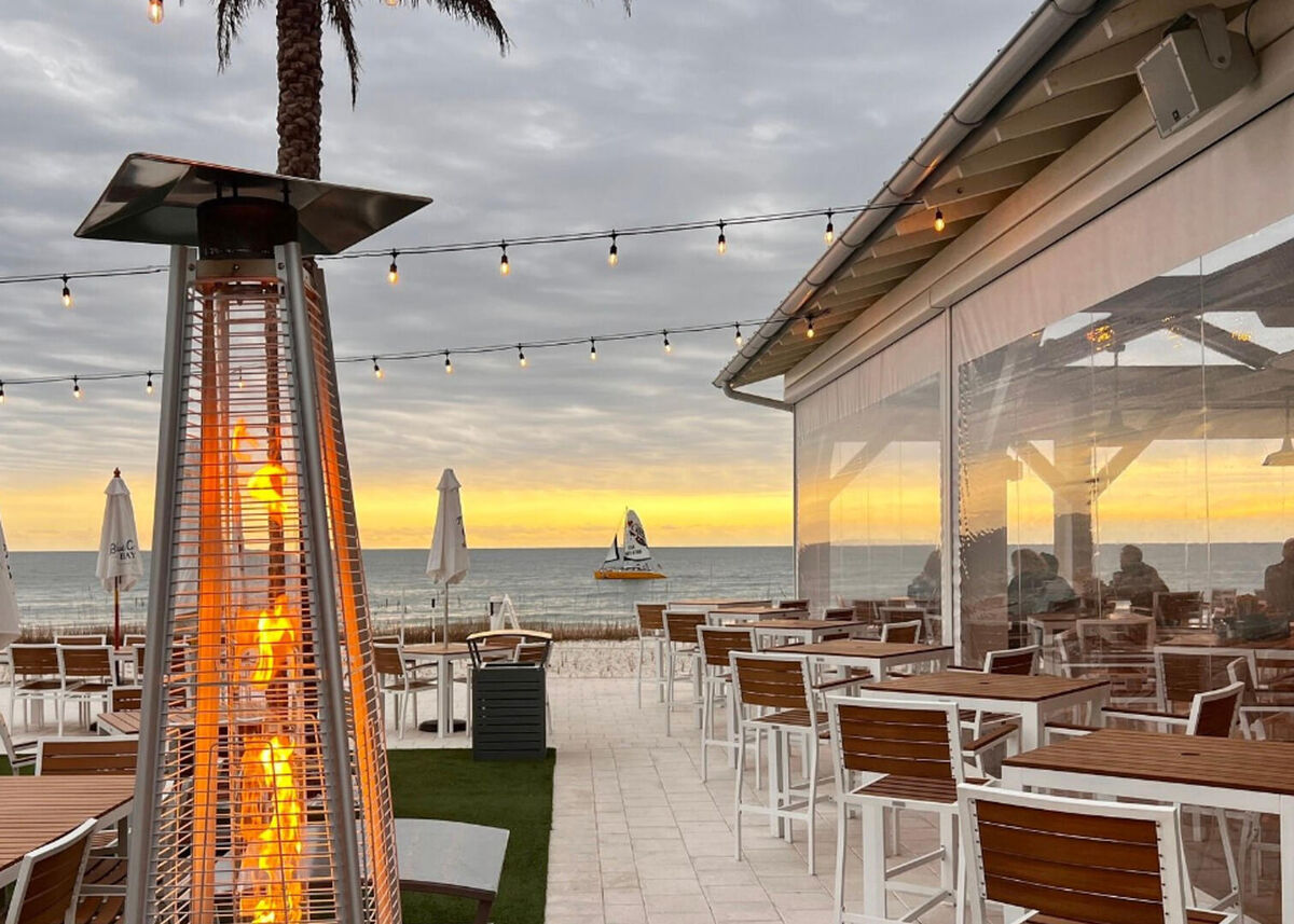 Enjoy a romantic meal on the back patio overlooking the beach at Coastal Restaurant in nearby Orange Beach, AL