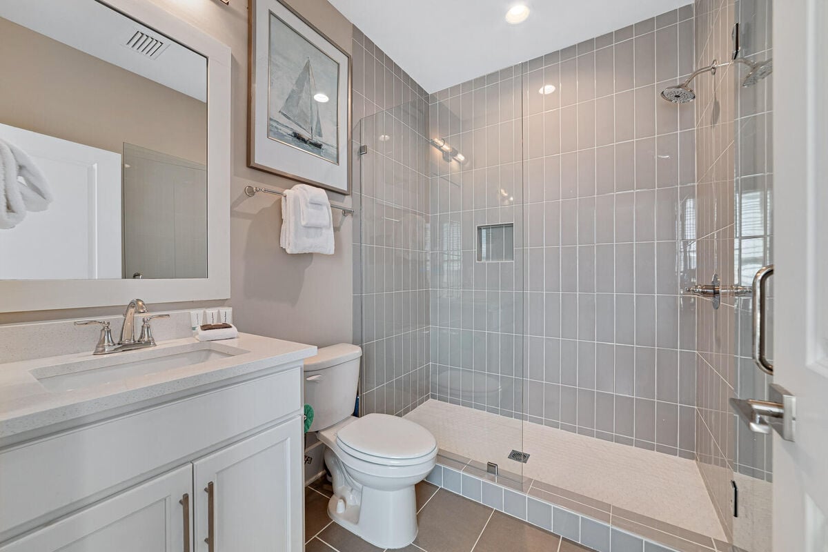 Each guest room upstairs has its own private bathroom with a splendid walk-in shower, making each wash feel like a spa experience.