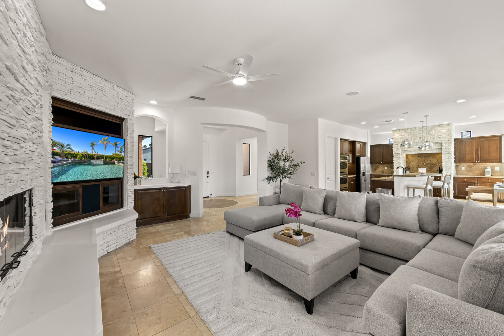 In the living room, relax in front of a 65-inch Samsung Smart television and a natural gas fireplace.