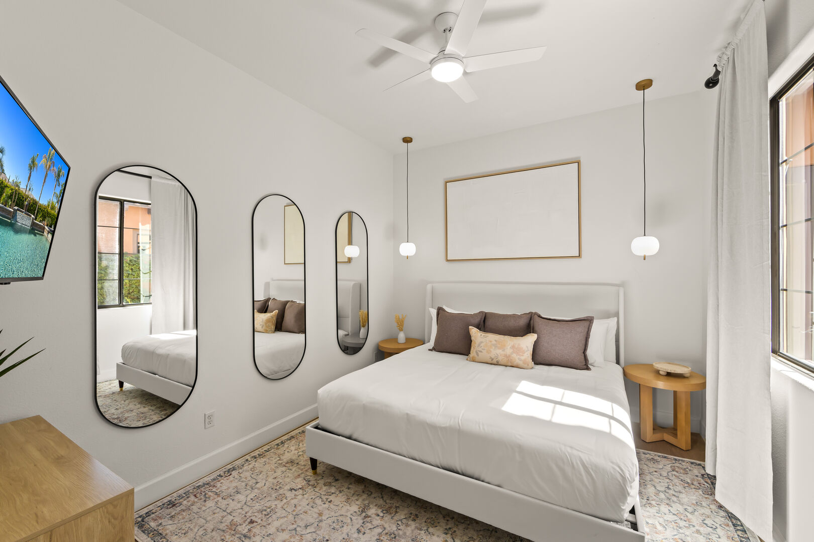 Bedroom 4 is located next to the front doors and features a King-sized Bed, 43-inch Insignia Smart television, remote-controlled ceiling fan, and decorative pendant lamps.