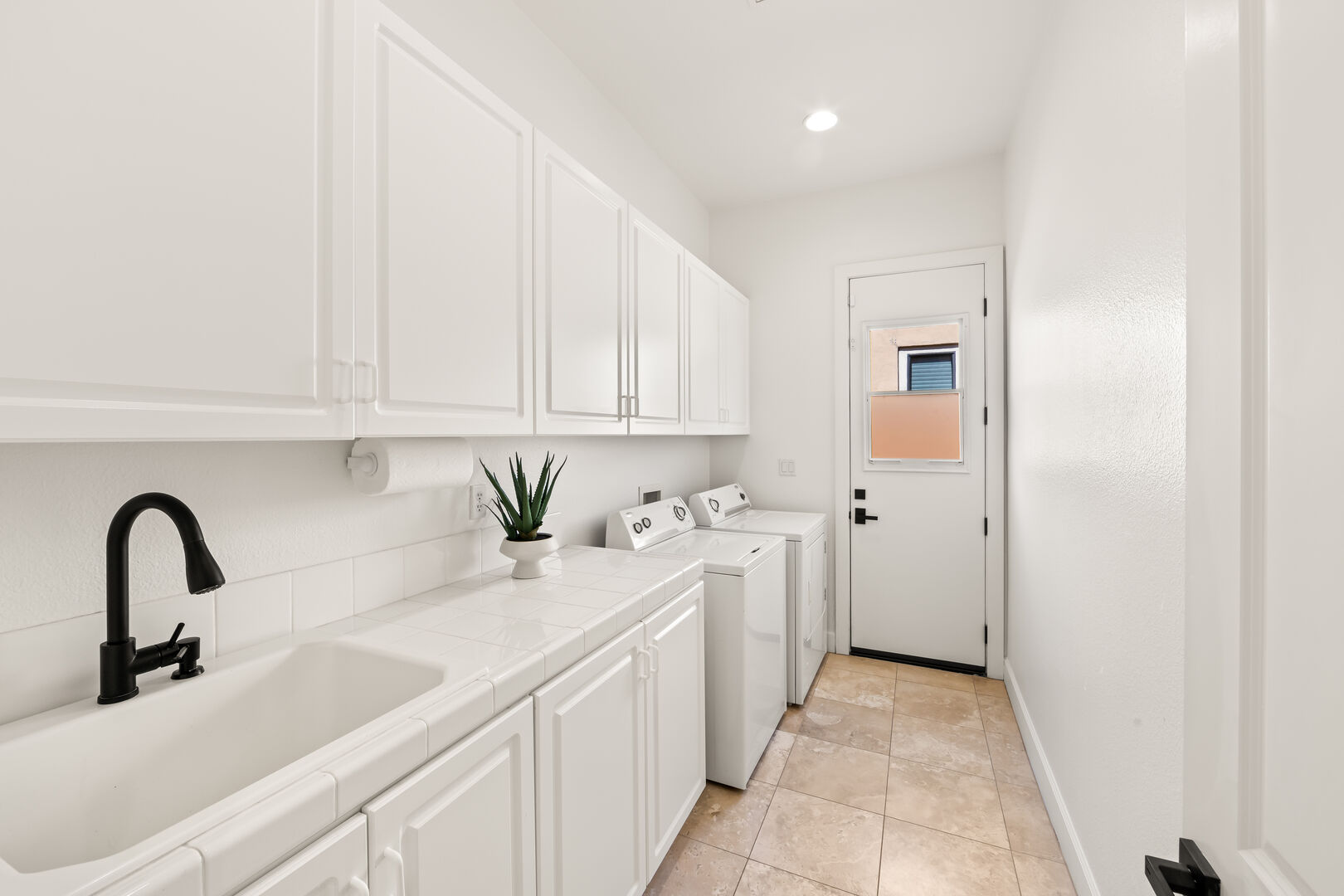 In the fully equipped laundry room, you'll find a washer, dryer, iron, ironing board, and laundry pods for added convenience.