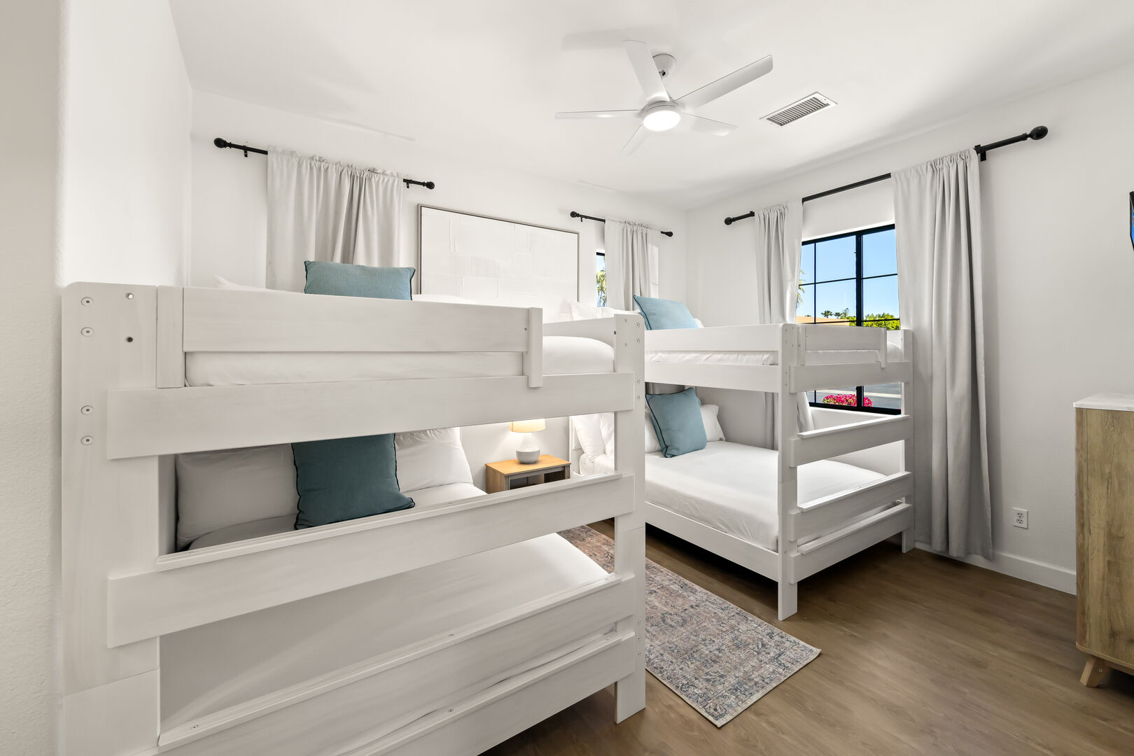 Suite 2 features 2 Queen Over Queen Bunk Beds, a 43-inch Insignia TV, and a walk-in closet.