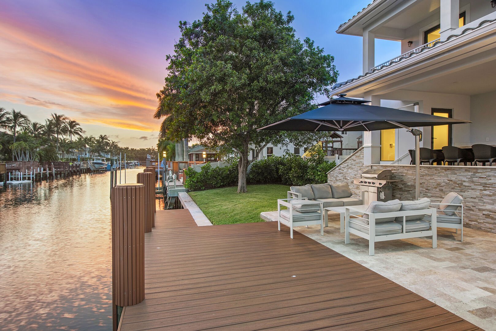 Waterfront tranquility from the backyard and its lounge areas, ideal for entertaining.
