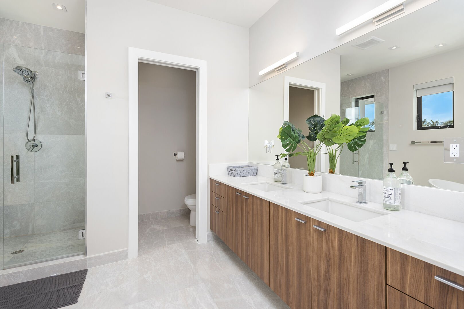 The primary bathroom features a walk-in shower, double sinks and a bathtub.