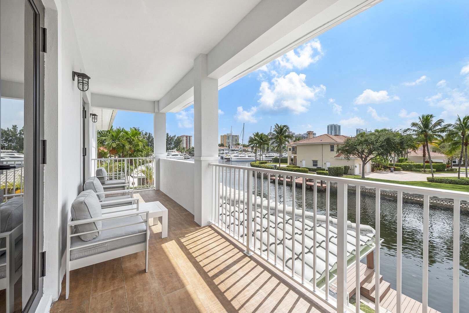 The balcony off the primary bedroom showcases canal views just off the Intracoastal waterway.