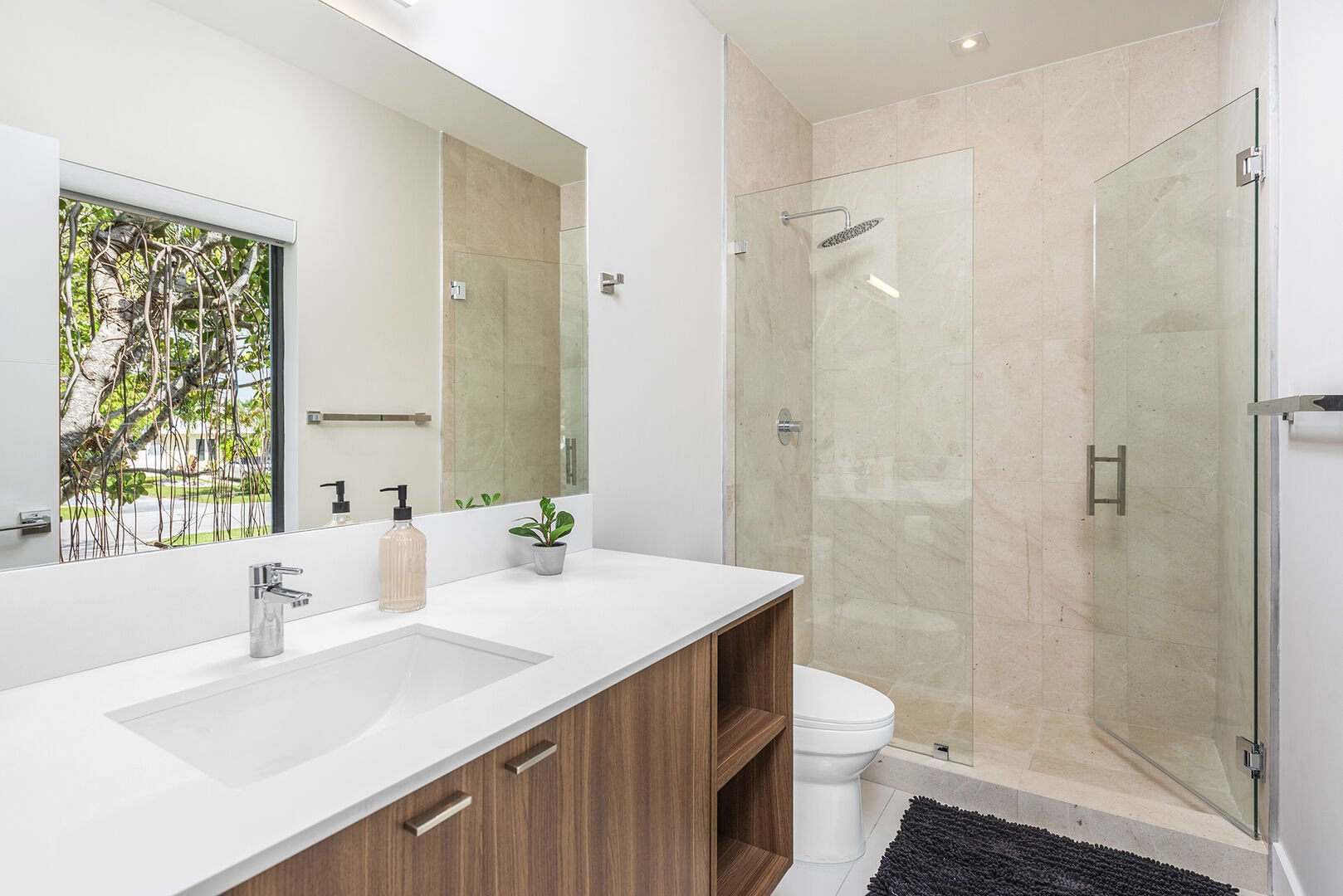 The ensuite bathroom features a walk-in shower with Fiji amenities and Comphy opulent towels.