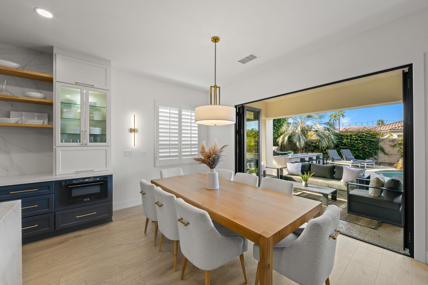 Move seamlessly into the dining area, where a formal dining table with seating for 8 awaits.