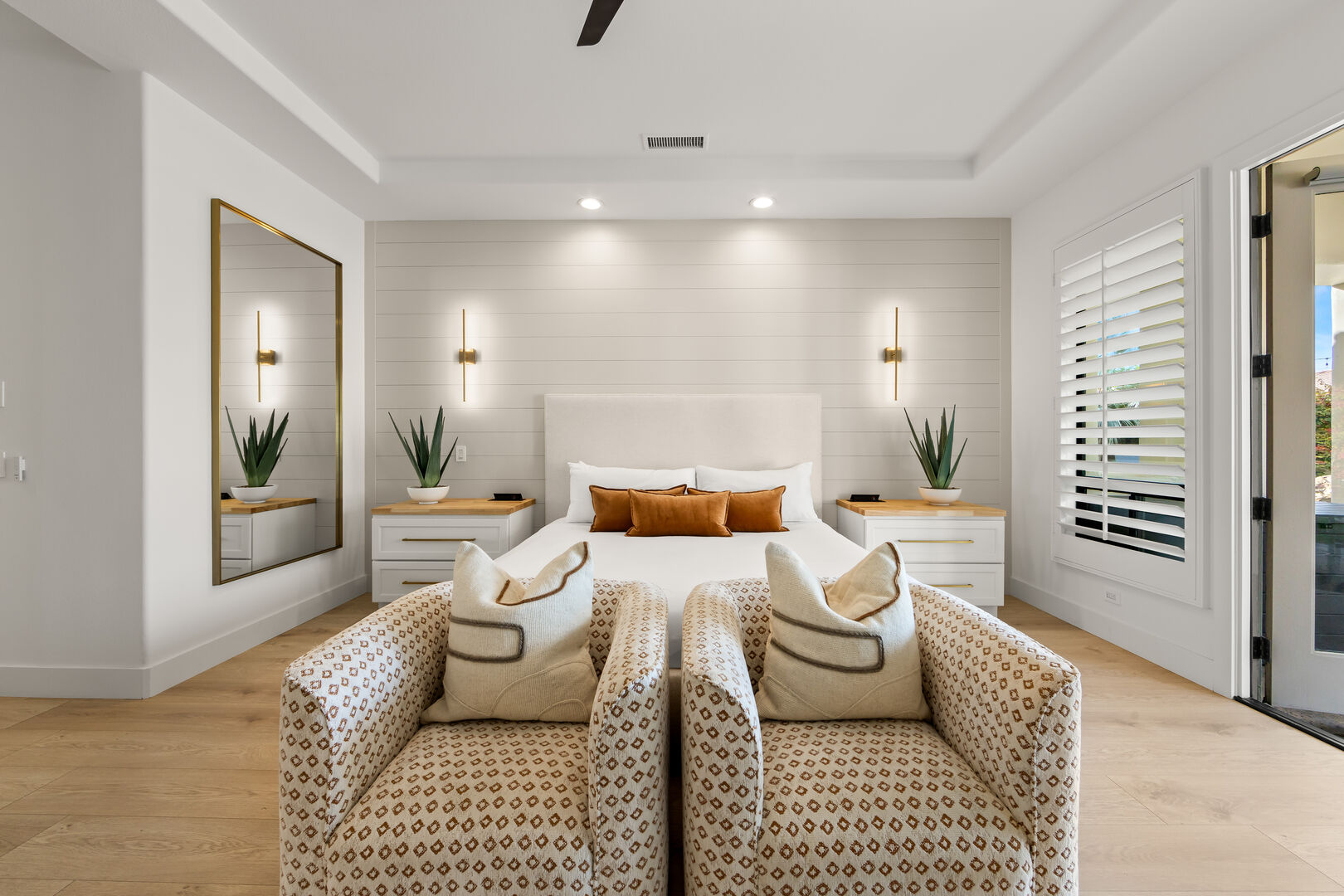 Master Suite 1 is located next to Hallway Bathroom 2 and features a King-sized Bed, 75-inch Samsung 4K Smart television, remote-controlled ceiling fan, and a walk-in closet.
