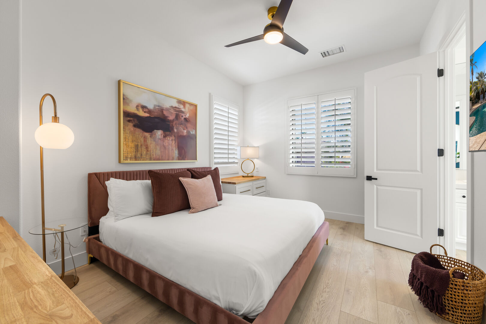 Jack and Jill Bedroom 2 is located next to the front entrance doors and features a King-sized Bed, a 55-inch Samsung 4K Smart television, a remote-controlled ceiling fan, and a floating dresser with wide, spacious drawers for all your storage needs.