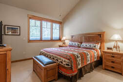 Master bedroom on the top level with a  king bed and flat screen tv with ensuite full bathroom and walk in closet