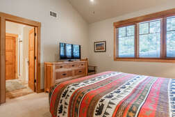 Master bedroom on the top level with a  king bed and flat screen tv with ensuite full bathroom and walk in closet