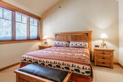master bedroom on the top level with a  king bed and flat screen tv with ensuite full bathroom and walk in closet