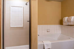En-suite master bathroom with shower and tub