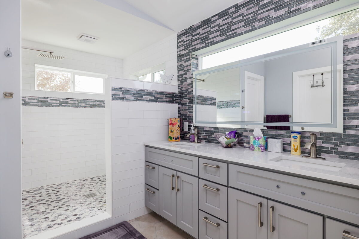 Sleek and clean modern bathroom with dual vanity and walk-in shower