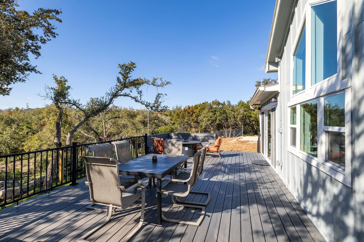 Expansive deck with outdoor dining set and sweeping views of the natural surroundings