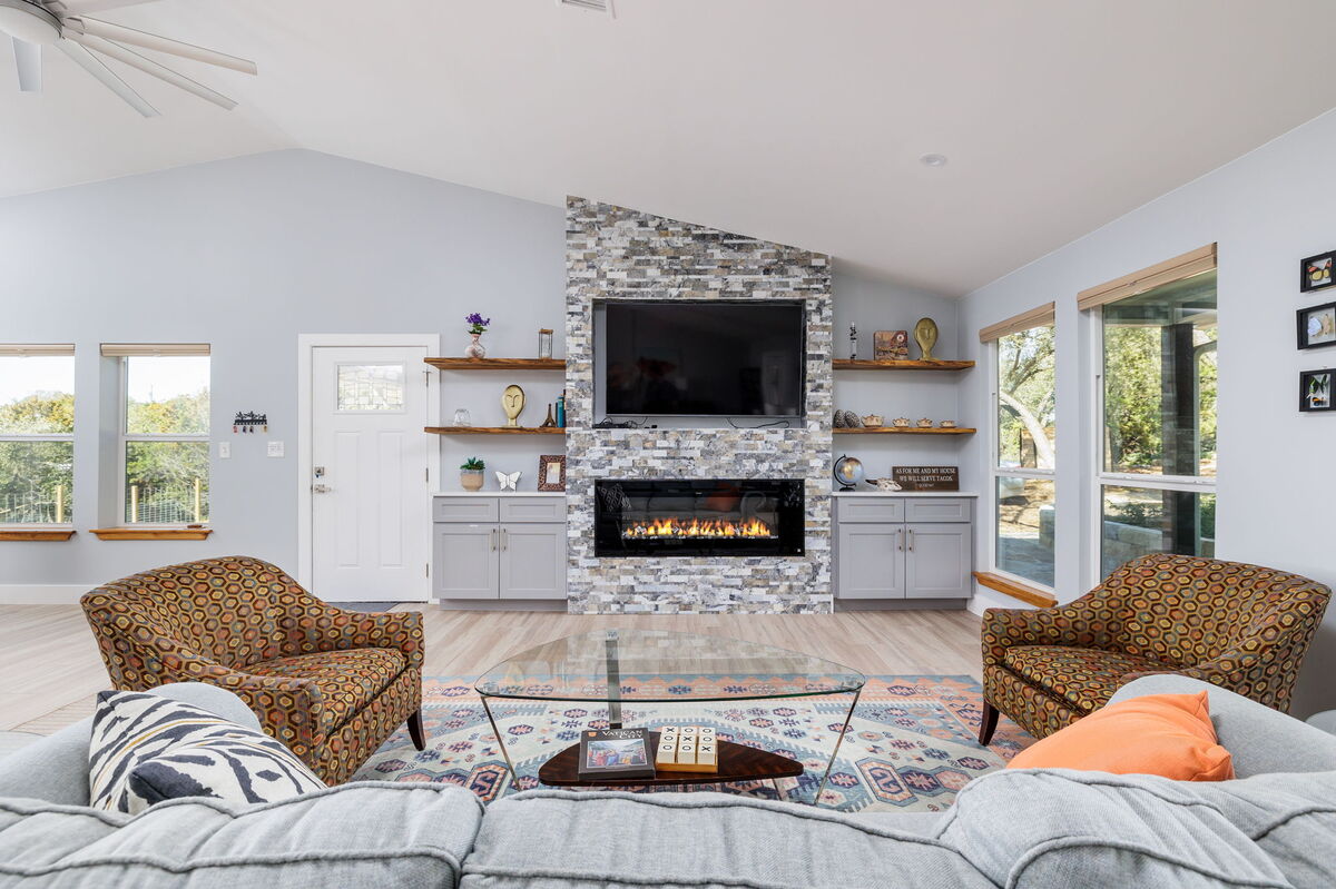 Relax in the charming living room, anchored by a striking stone fireplace