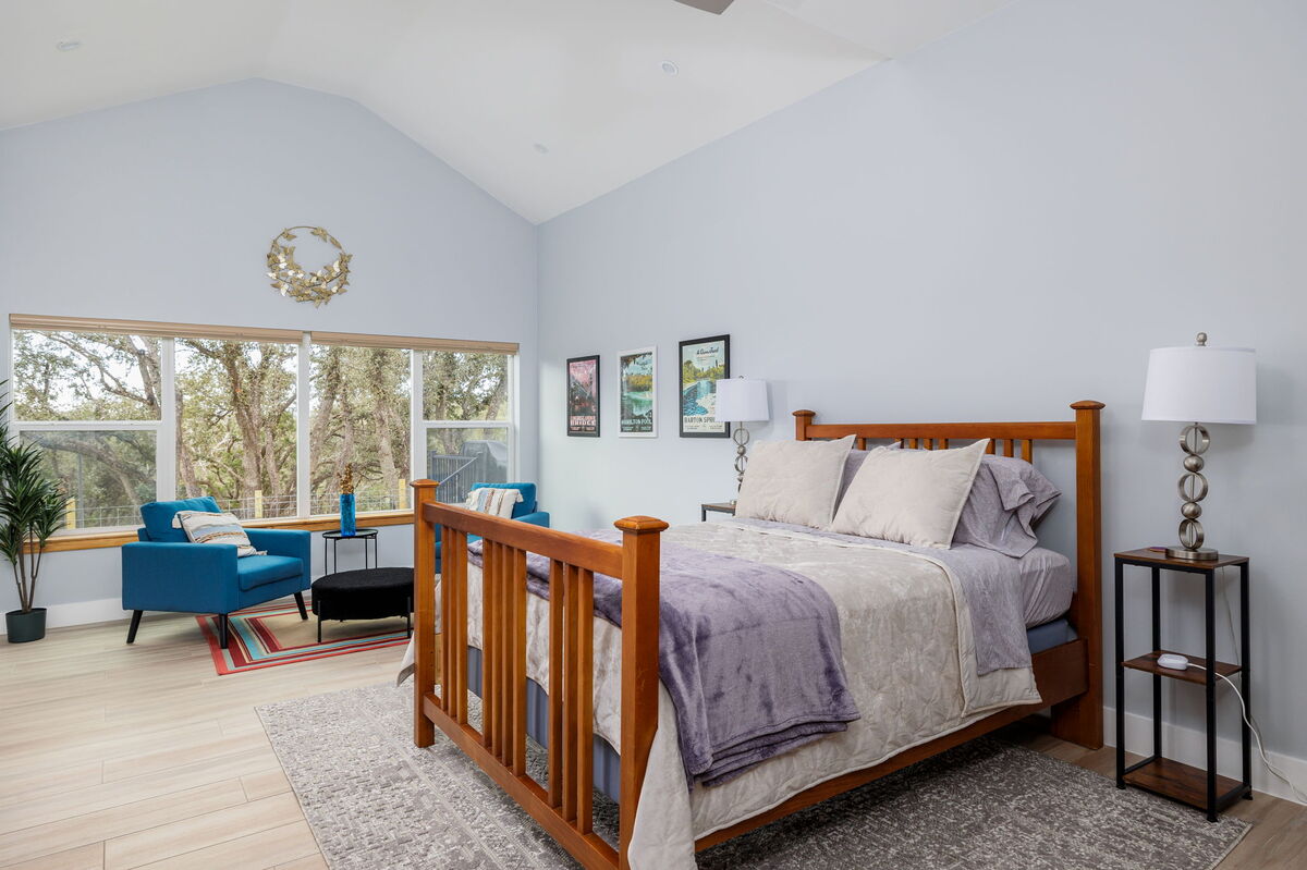 Master suite features a comfortable queen bed and peaceful woodland ambiance
