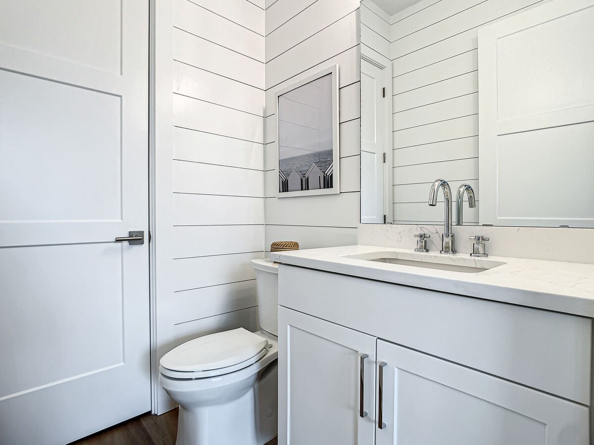 Our downstairs half bathroom with patio access offers the perfect blend of comfort and accessibility for your vacation needs.