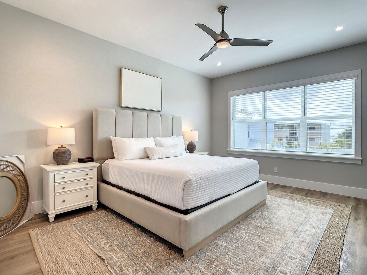 Our sun-kissed master suite features a king-size bed, perfect for basking in the glow of natural lighting.