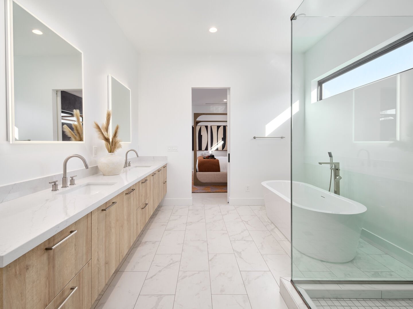 Luxurious Primary Bathroom (Primary Bedroom en-suite) featuring a dual vanity with a soaking tub and a stand-in shower.