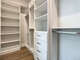 Huge master closet with plenty of shelving and hanging spaces.